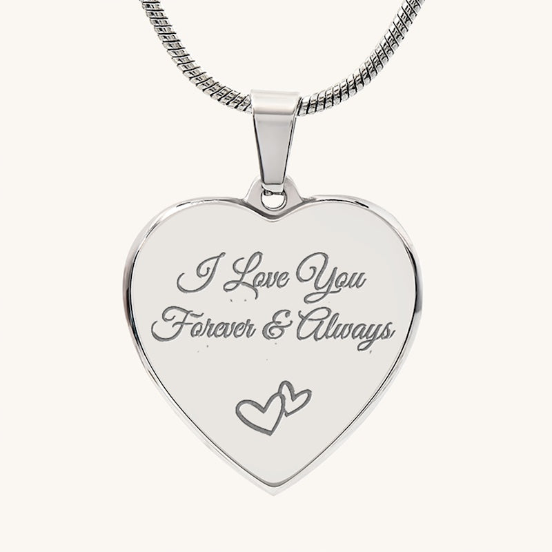 Silver heart-shaped pendant with 'I Love You Forever & Always' engraving on a white background