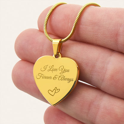 Gold heart-shaped pendant with 'I Love You Forever & Always' engraving held in a hand.