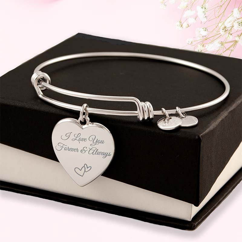 Personalized gifts for her: Silver bracelet with heart-shaped engraved charm on a black box