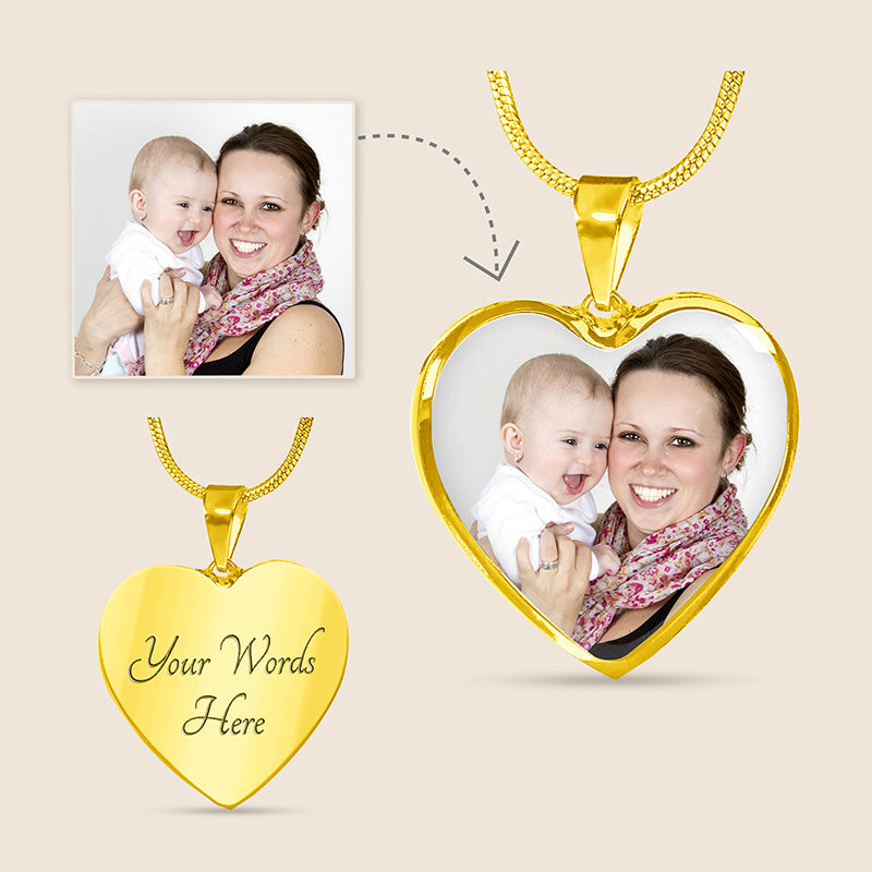 engraved heart necklace with photo: heart-shaped gold pendant with customizable text and a photo of a woman holding a baby.