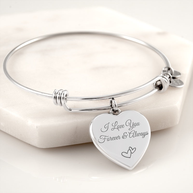 Unique gifts for her: Silver custom engraved bracelets with a heart-shaped tag engraved with 'I Love You Forever & Always' on a white background.