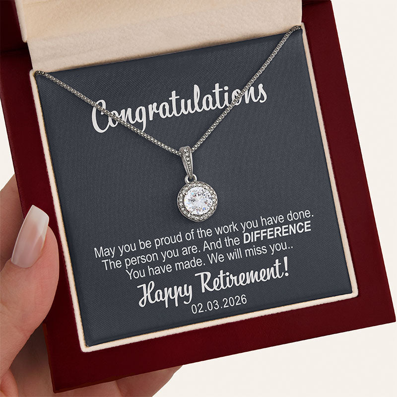 Retirement jewelry necklace with a round sparkling pendant in a red wooden box with a card message
