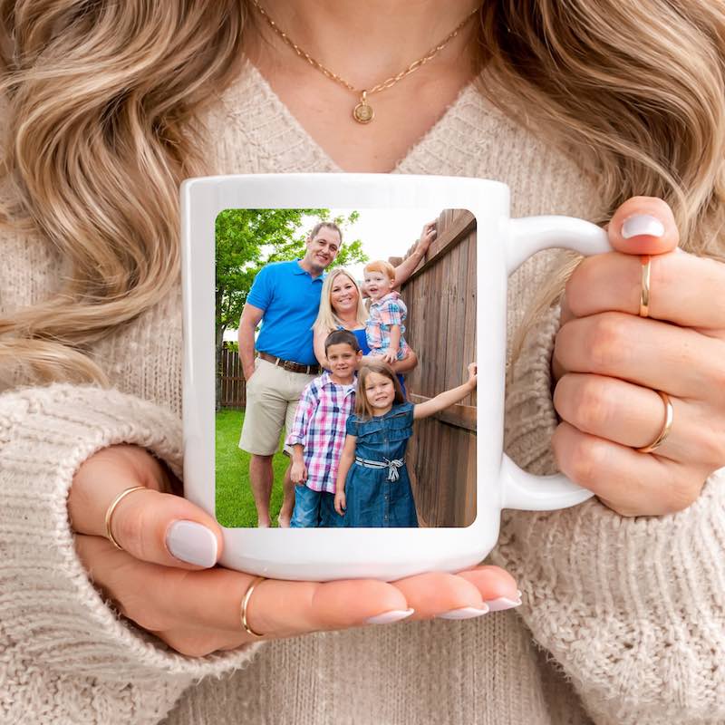 Person holding a custom mug with a family photo printed on it