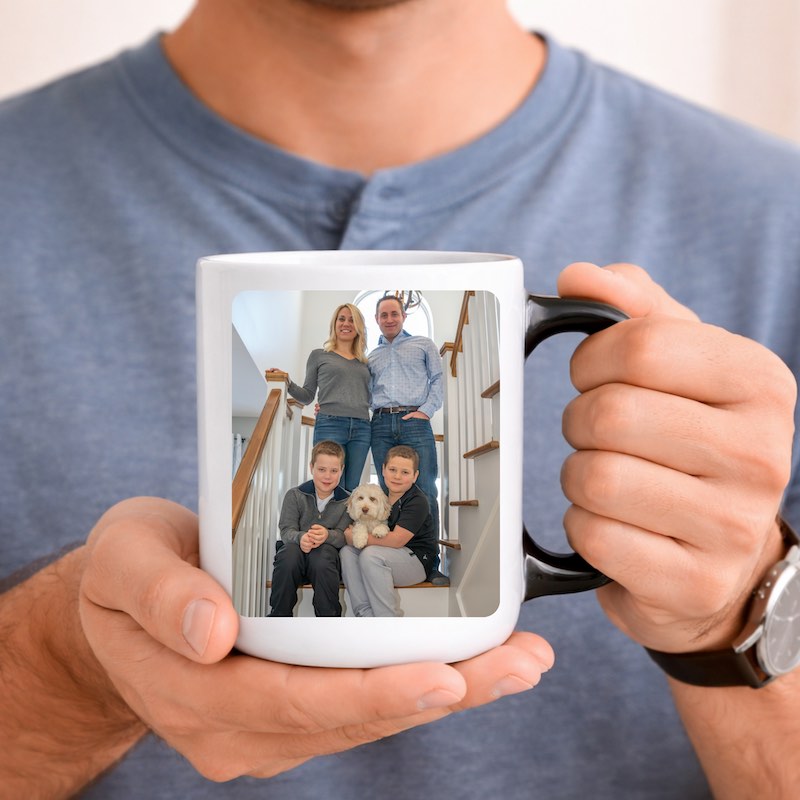 custom photo mug: a man holding a coffee mug with a family picture on it.