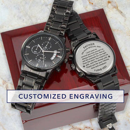 fathers day watches: two black metal wristwatches displayed on a red presentation box over a light marble surface. One watch face is visible, and the other is turned over to show engraved text on the back.