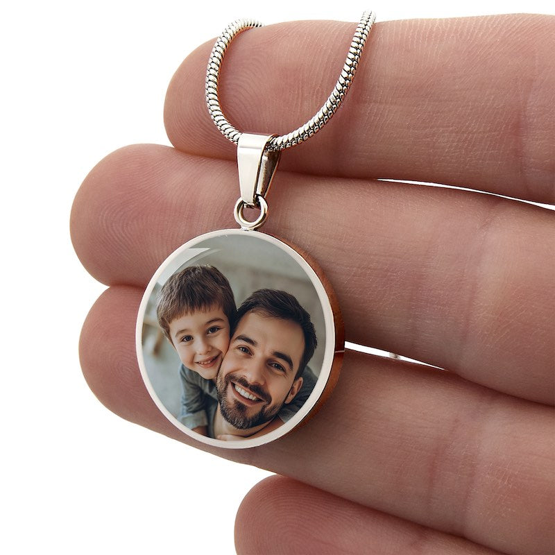 Silver personalized circle photo pendant necklace with father and son image held in hand