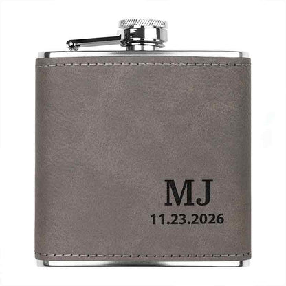 Stainless steel custom engraved flask in  gray color, showing customized initials and date engraving.