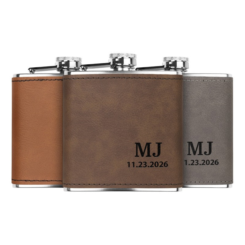Stainless steel custom engraved flask in dark brown, gray, and rawhide colors, showing personalized initials and date engraving.