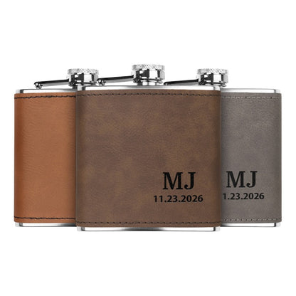 Stainless steel custom engraved flask in dark brown, gray, and rawhide colors, showing personalized initials and date engraving.