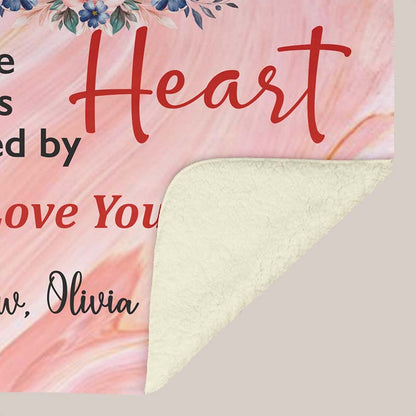 Pink floral-themed blanket with text for grandparents from grandchildren showing the underside white sherpa, on a beige background.