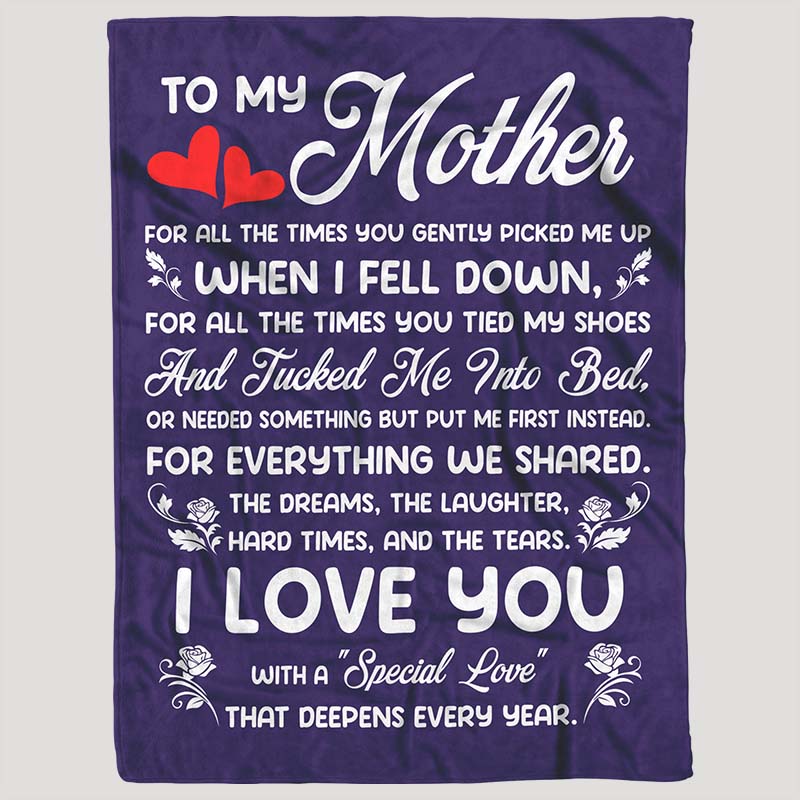 Purple fleece blanket featuring a meaningful message for a mother in white text, accented with red hearts, on a gray background