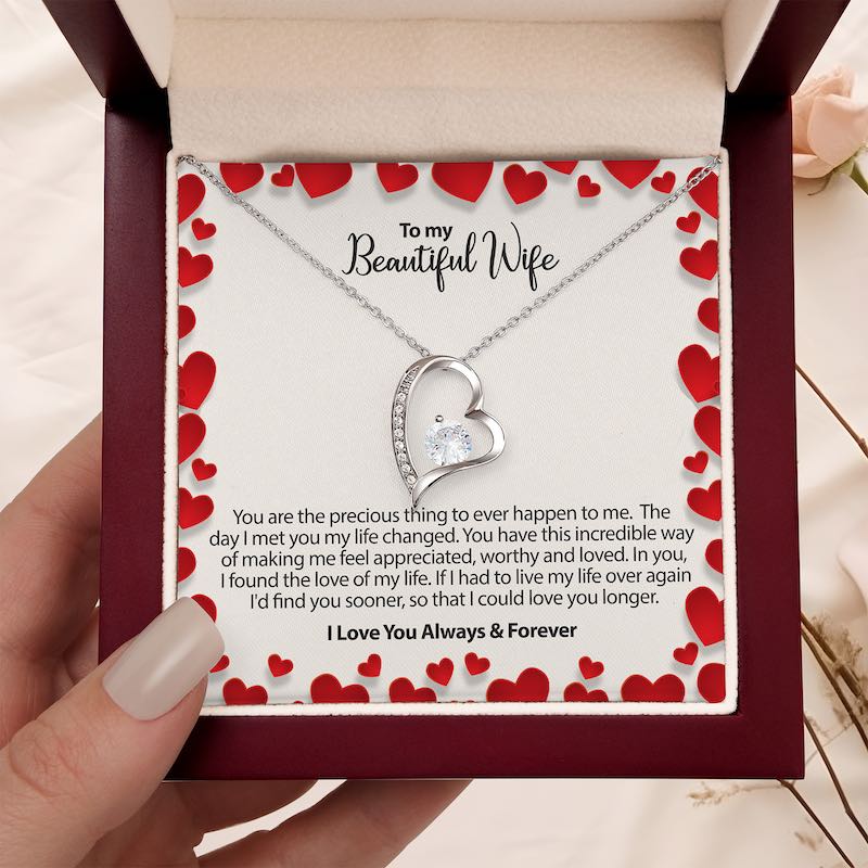 to my wife gifts - heart-shaped necklace in a box with a sentimental message for a wife in a burgundy box on a beige background.