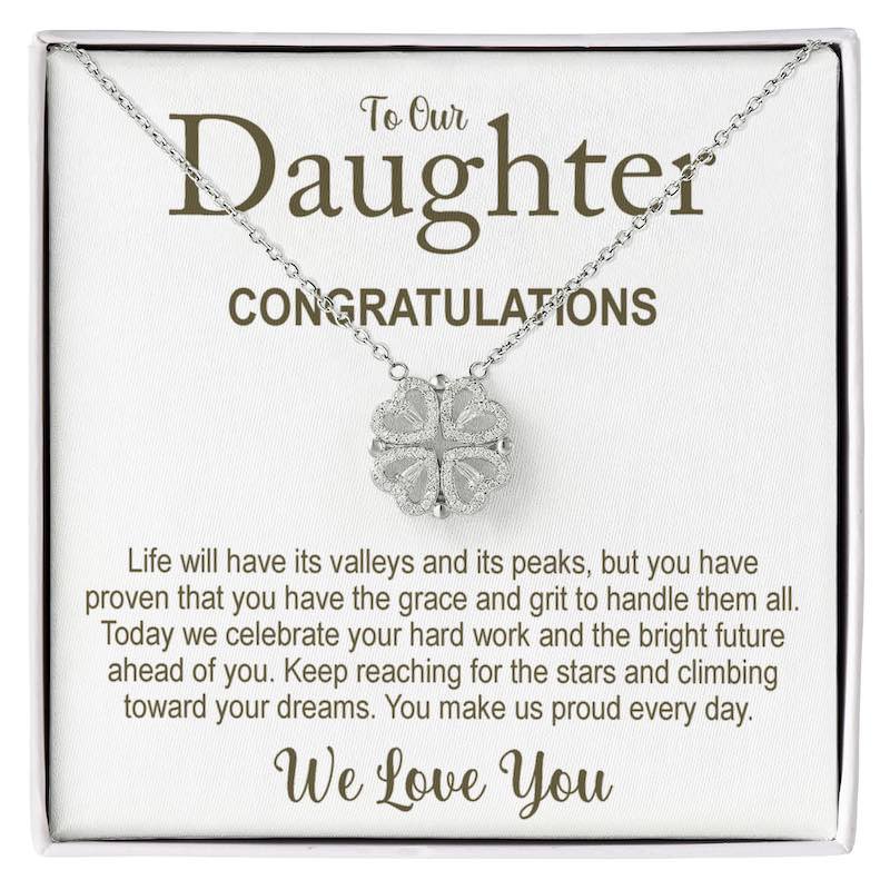 Necklace with clover pendant on a card for daughter, celebrating her achievements.