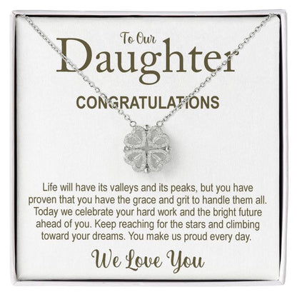 Necklace with clover pendant on a card for daughter, celebrating her achievements.