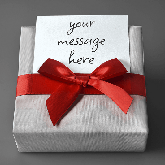 A gift box wrapped with a red satin ribbon bow and a custom gift card reading "your message here."