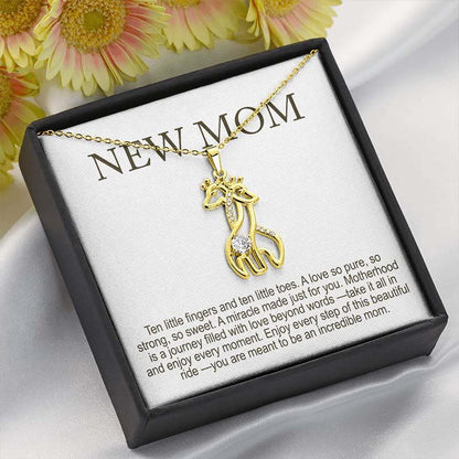 new mom gifts from husband: gold giraffe pendant necklace with crystal detail displayed in a black gift box with “New Mom” message card