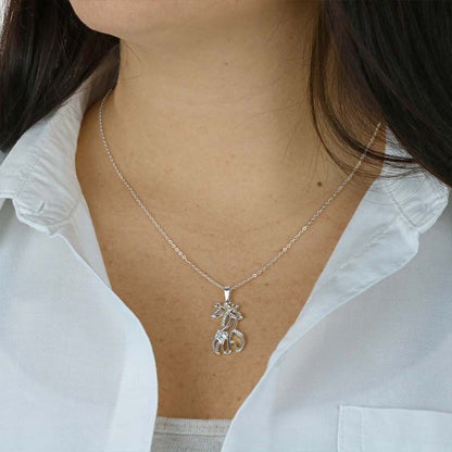 Silver giraffe pendant necklace worn by a woman, delicate chain with crystal accents—elegant gift jewelry for moms