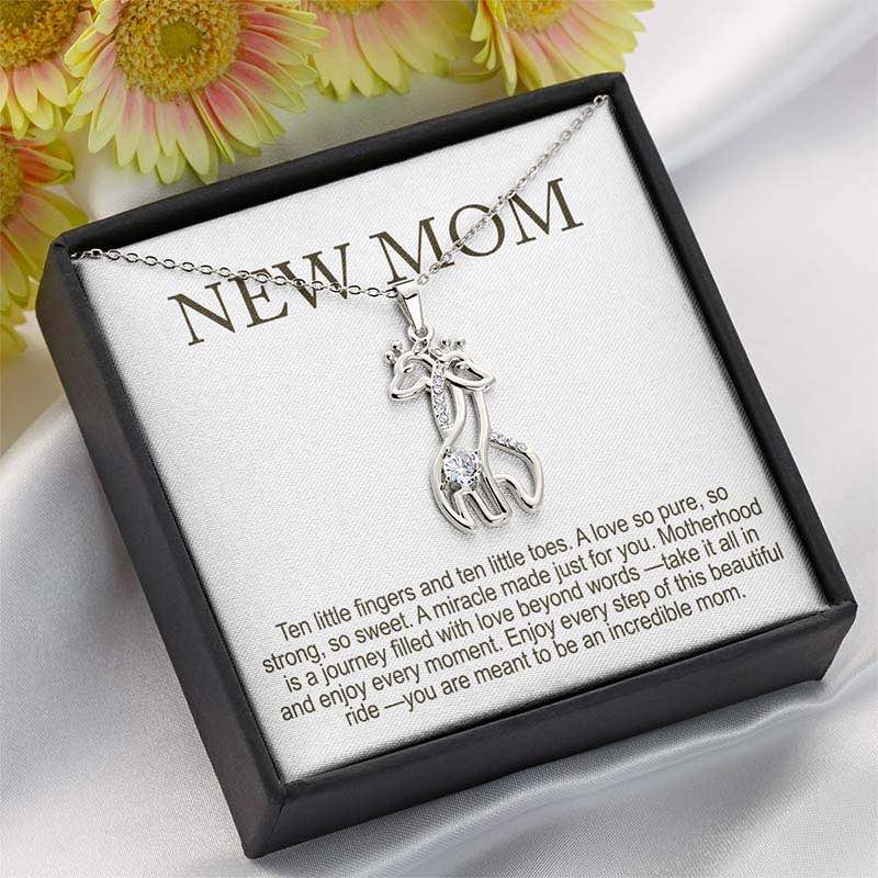 unique new mom gifts: silver giraffe pendant necklace with crystal detail displayed in a black gift box with “New Mom” message card