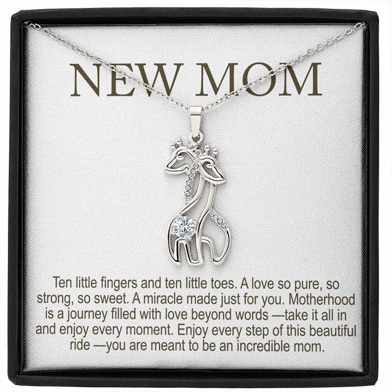 personalized new mom gifts: silver giraffe pendant necklace with sparkling stones displayed in a gift box with “New Mom” message card