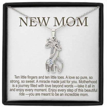personalized new mom gifts: silver giraffe pendant necklace with sparkling stones displayed in a gift box with “New Mom” message card