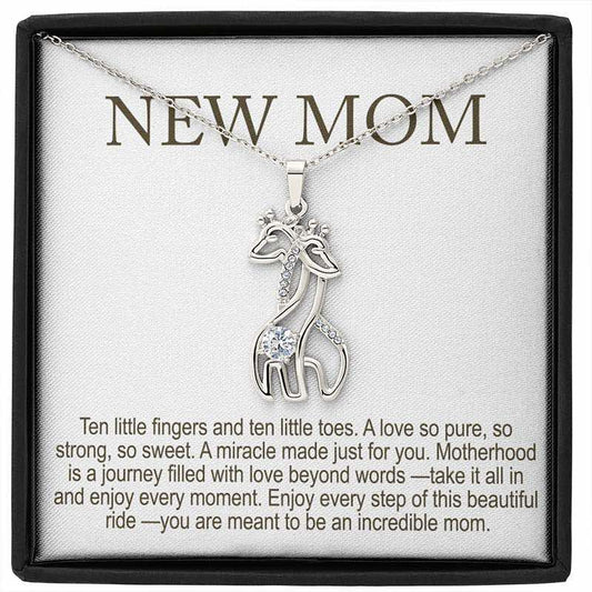 personalized new mom gifts: silver giraffe pendant necklace with sparkling stones displayed in a gift box with “New Mom” message card