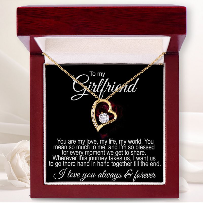 Girlfriend jewelry gifts: An open luxury mahogany-style gift box displaying a gold heart-shaped necklace with a central crystal and a romantic "To my Girlfriend" message card.   