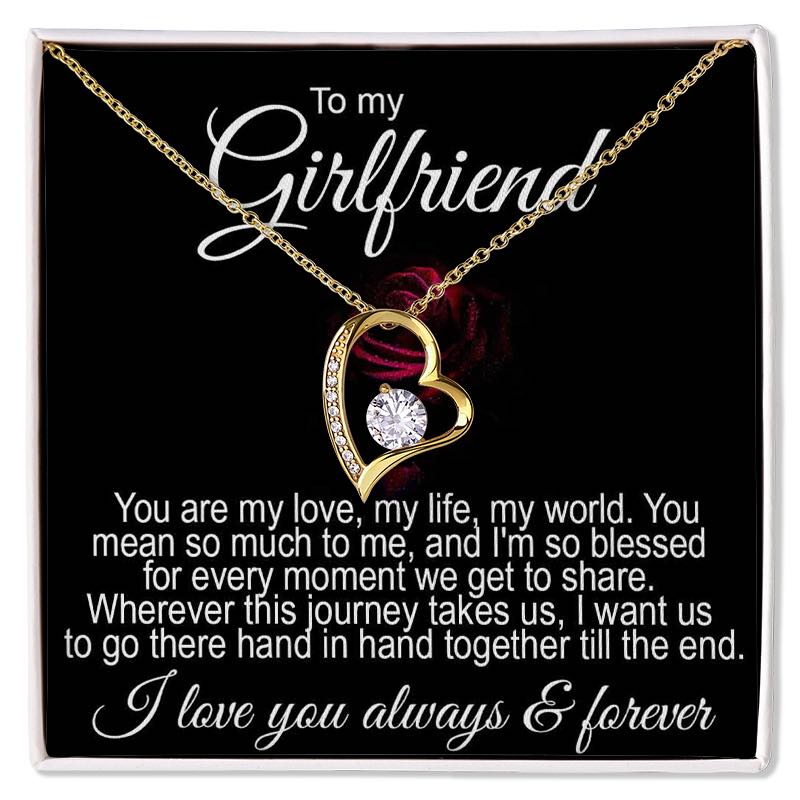 Romantic gifts for girlfriend: A gold heart-shaped necklace featuring a central sparkling crystal, displayed inside a gift box with a romantic "To my Girlfriend" message card.   