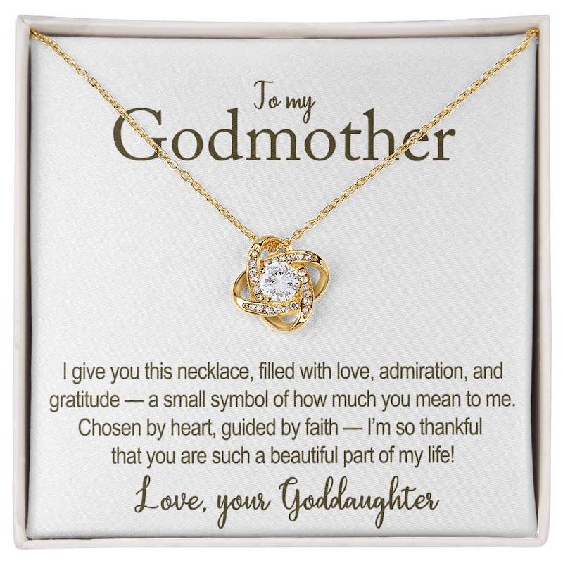 Gold necklace with heart-shaped pendant on a card for a godmother, featuring a heartfelt message.