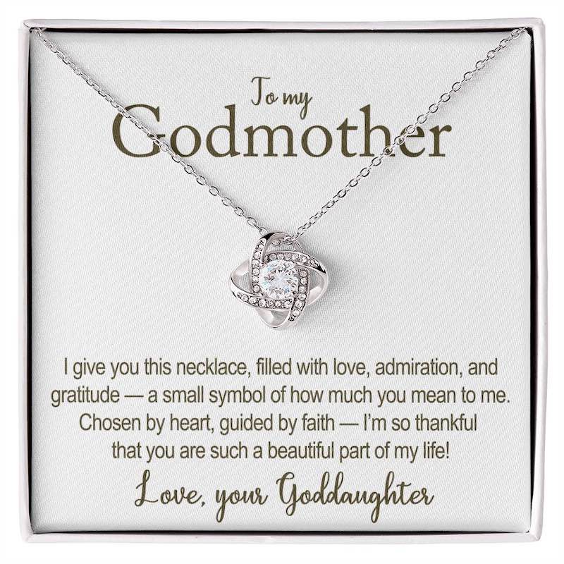 Necklace with heart-shaped pendant on a card addressed to a godmother, featuring a heartfelt message.