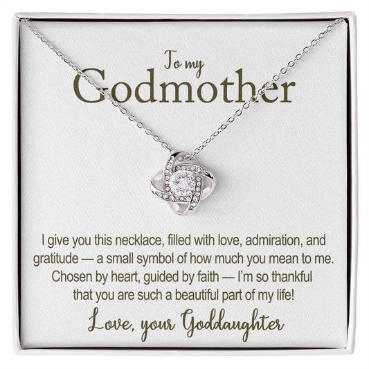 Necklace with heart-shaped pendant on a card addressed to a godmother, featuring a heartfelt message.