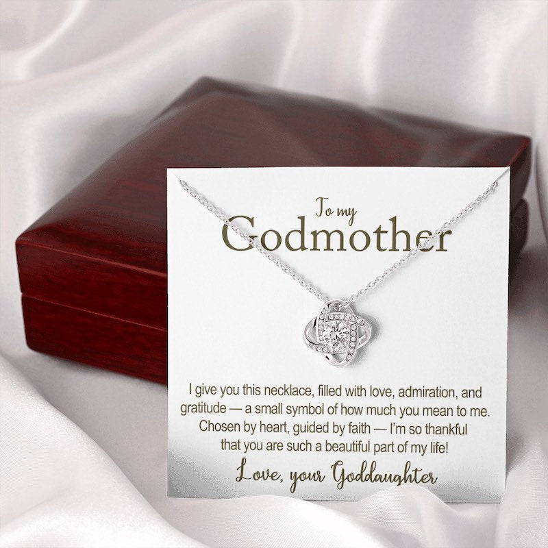 Necklace with a card for a godmother on a white fabric background in a mahogany style box