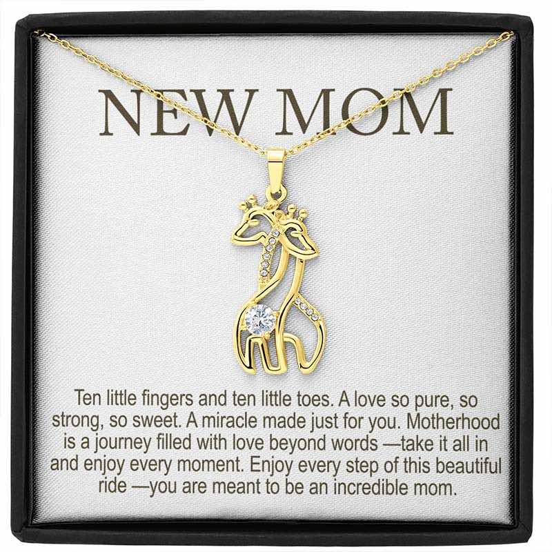 new mom gifts: gold giraffe pendant necklace with sparkling stones displayed in a gift box with “New Mom” message card