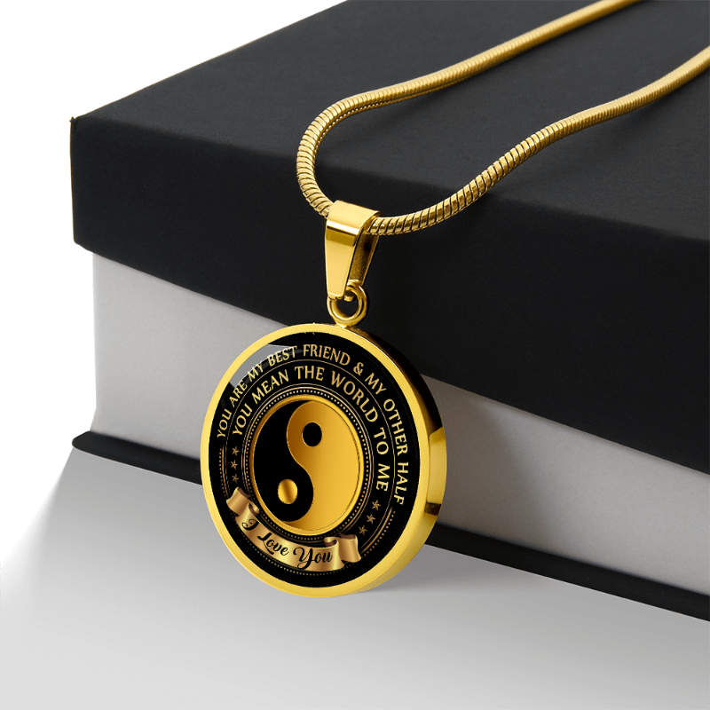 Gold Yin Yang Necklace with sentimental message laying on black/white gift box