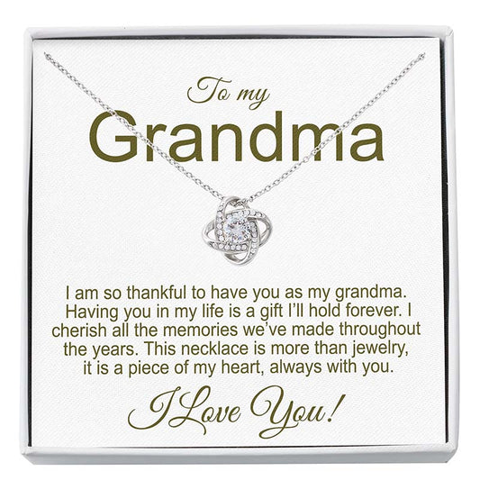 Necklace with a knot pendant on a card addressed to 'Grandma' with a sentimental message.