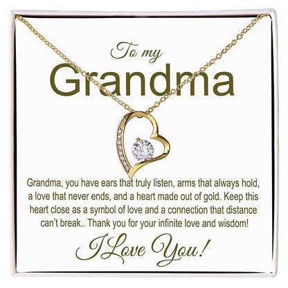 Gold heart-shaped necklace with a message card for grandma on a white background