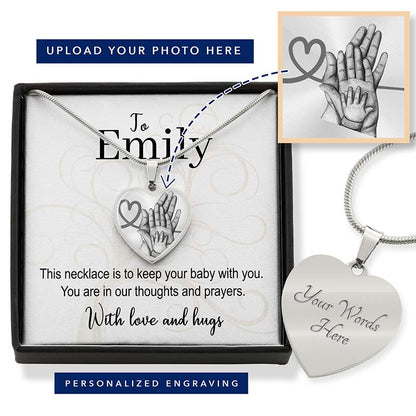 Necklace with heart-shaped pendant and engraved message, displayed in a box with additional pendant and engraving text.
