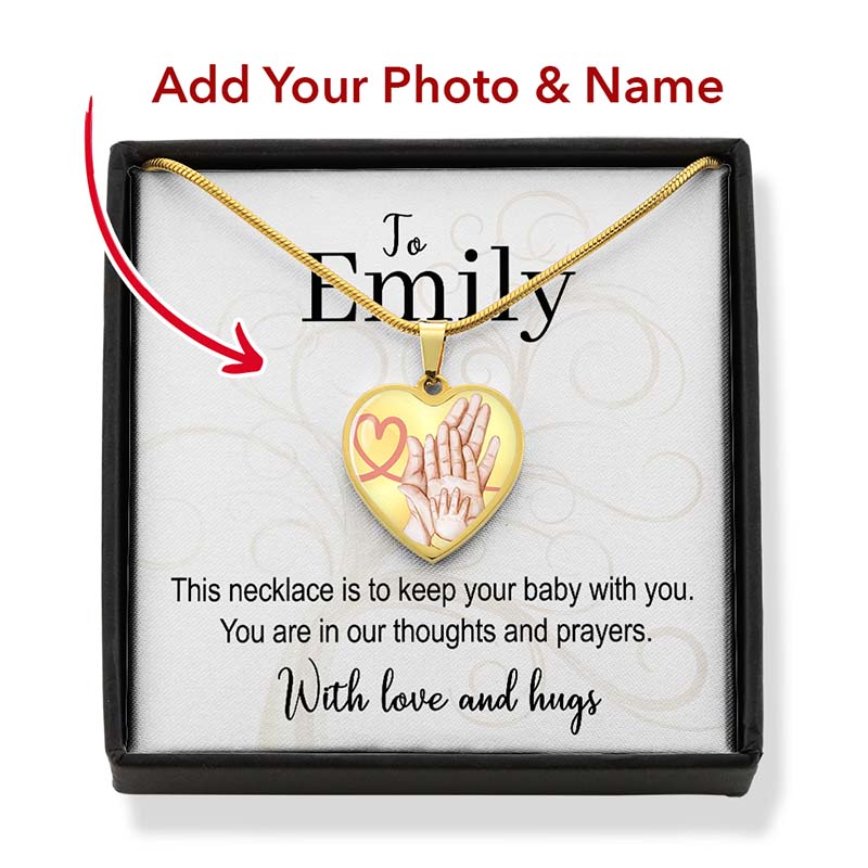 Heart-shaped necklace with baby hands design in a box, personalized for Emily.