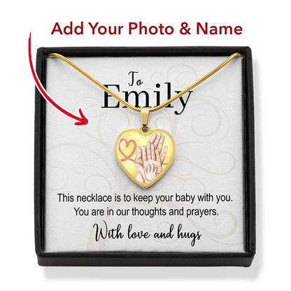 Heart-shaped necklace with baby hands design in a box, personalized for Emily.