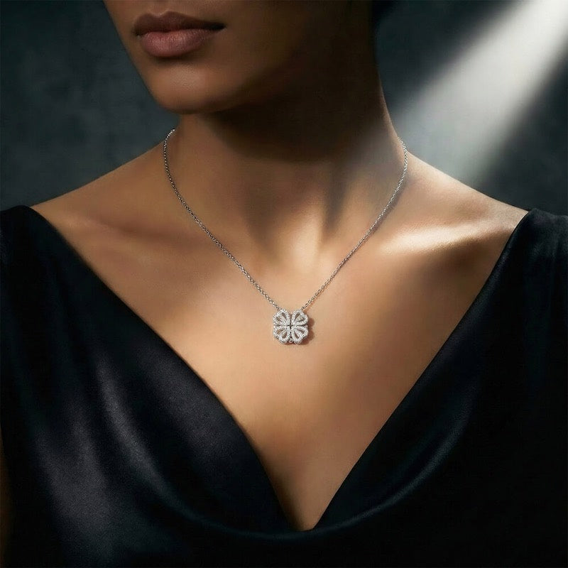 Silver necklace with a clover pendant on a dark background