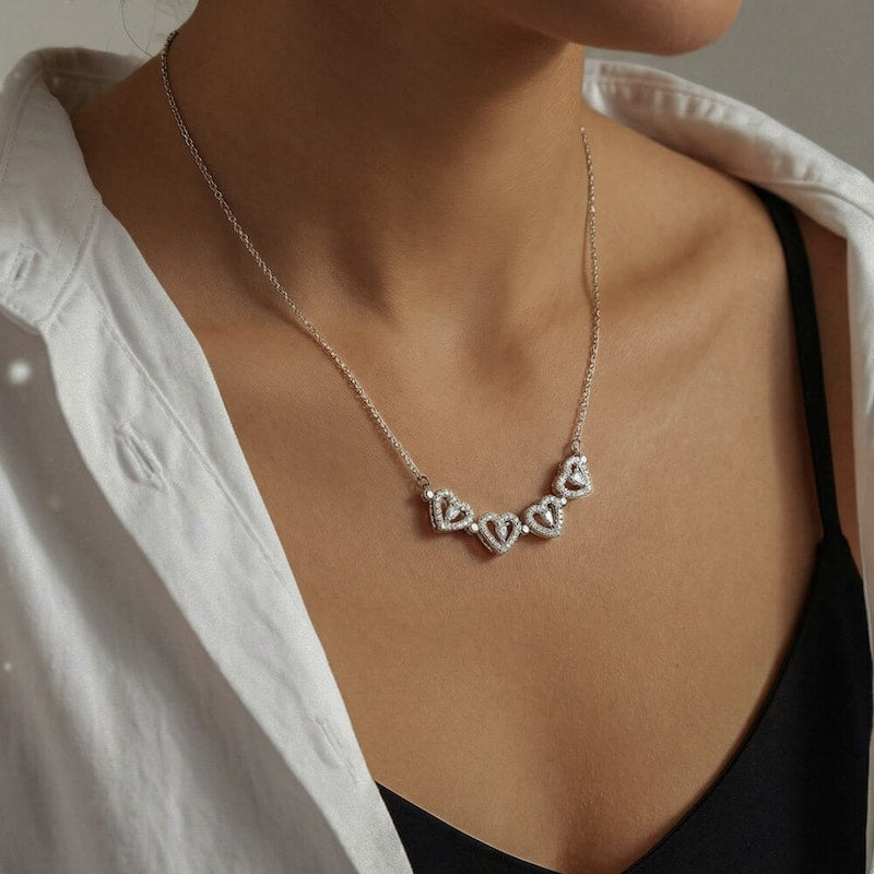Necklace with heart-shaped pendants worn by a person