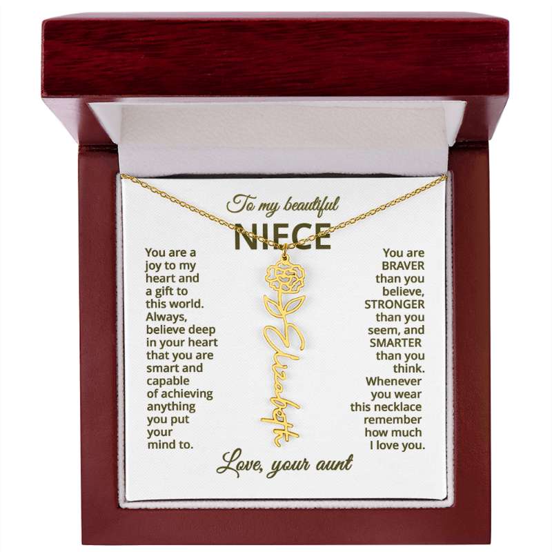 Gold necklace with carnation flower design on a sentimental message card in a wooden box.