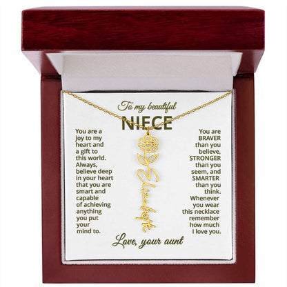 Gold necklace with carnation flower design on a sentimental message card in a wooden box.