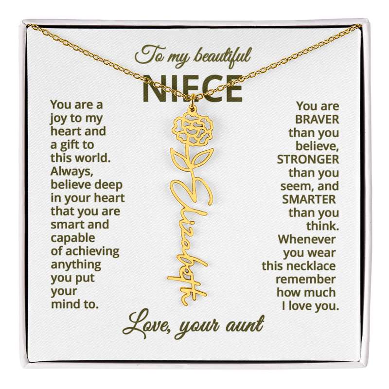 Gold necklace with carnation flower design on a card with personalized message, displayed against a white background.