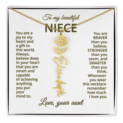 Gold necklace with carnation flower design on a card with personalized message, displayed against a white background.