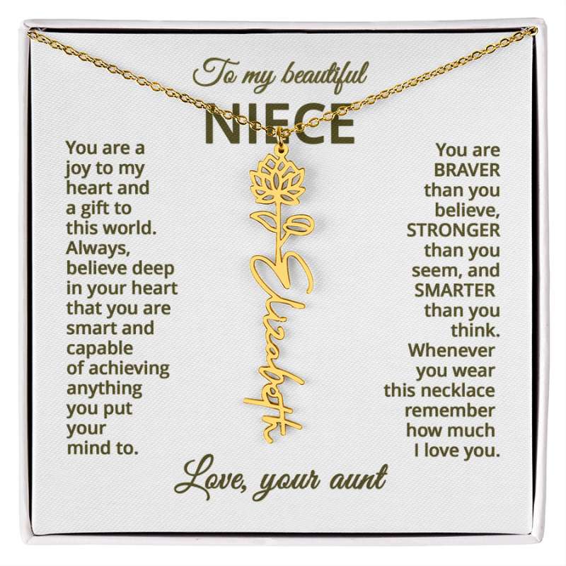 Gold name necklace and water lily pendant with a message card for a niece on a white background