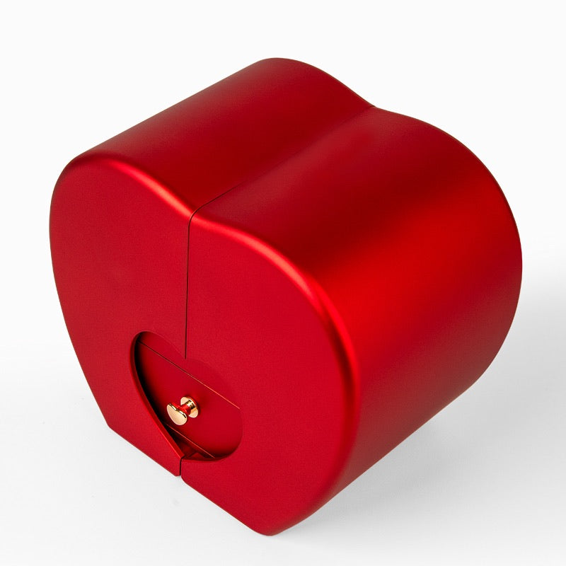 A red heart-shaped jewelry box with a small gold handle on the front, shown on a clean white background.