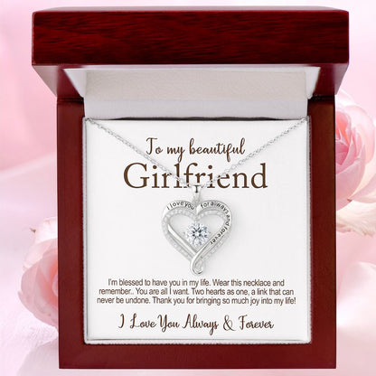 girlfriend jewelry gifts: silver heart-shaped diamond necklace in a jewelry box with the cad message: 'To my beautiful girlfriend, I love you for always and forever