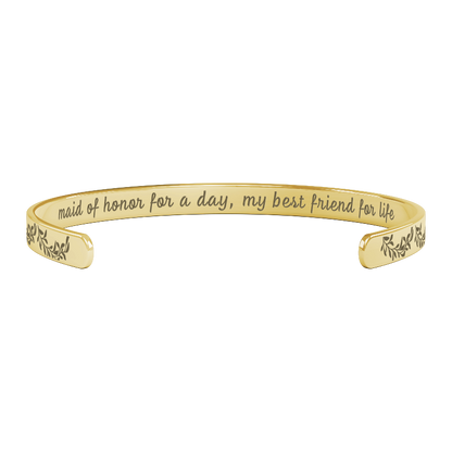 sentimental bridesmaid gifts - gold bracelet with engraved text on a white background