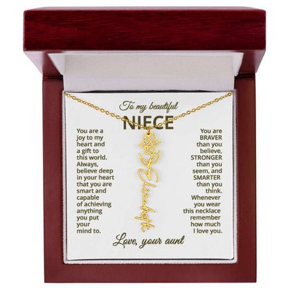 Gold necklace with daffodil flower design with engraved message on a white card for niece in a wooden box