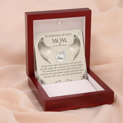 Silver angel wing necklace in a wooden box with a sentimental message for mom on a soft pink background